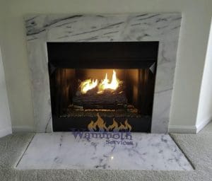 Gas_Fireplace_After_Wammoth burning gas fireplace with marble surround and hearth