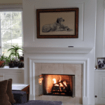 Room with burning fireplace and picture of a dog